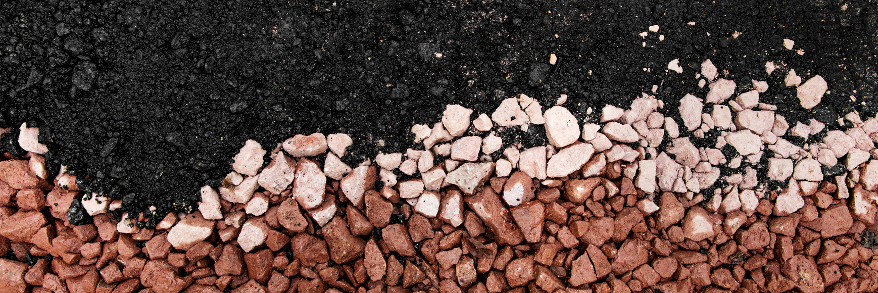 hot asphalt drying on base course with gravel and stones, panorama